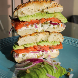 Loaded bagel sandwich with cream cheese, capers, red onion, nova lox and avocado