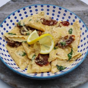 Lobster ravioli cooked in a creamy citrus sauce with sun-dried tomatoes and basil