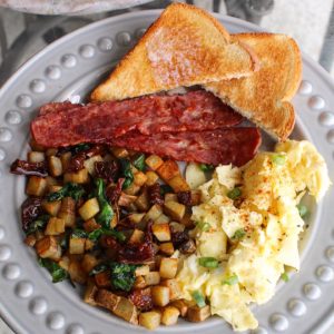 Loaded potatoes with scrambled eggs, turkey bacon and toast