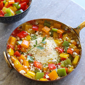 Diced bell peppers with a fried egg and feta cheese